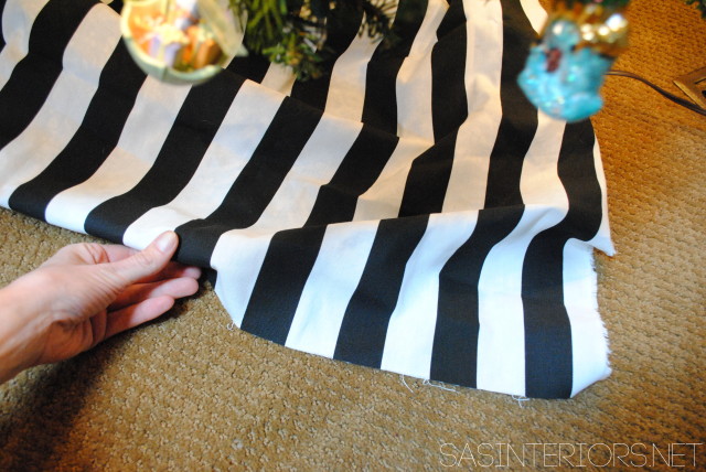 Easiest, Fastest, + Cheapest Christmas Tree Skirt.  Use 1.5 yd of fabric and wrap around tree.  Follow easy instructions by @Jenna_Burger of WWW.JENNABURGER.COM
