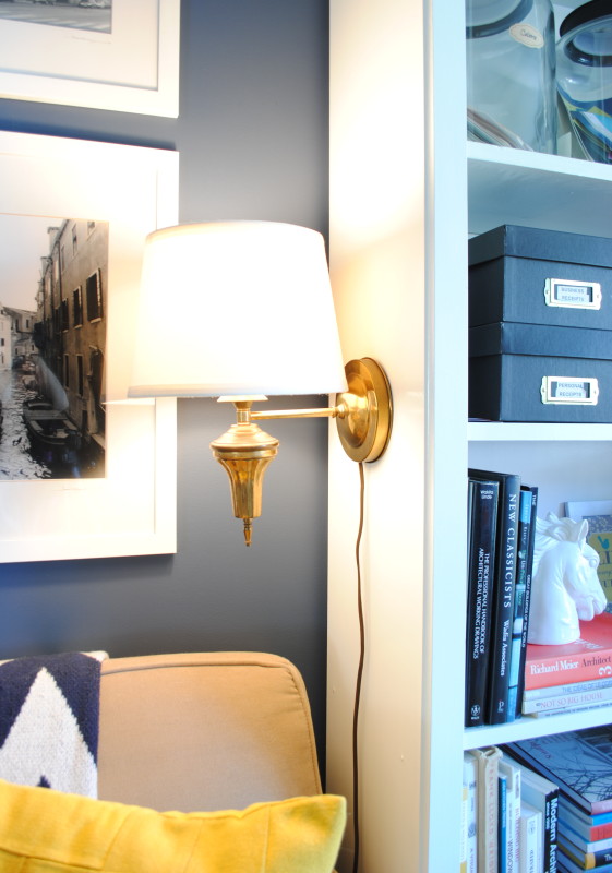 Home Office / Family room with new wall sconce on the side of the bookcase. The perfect thrift store find brought back to life!