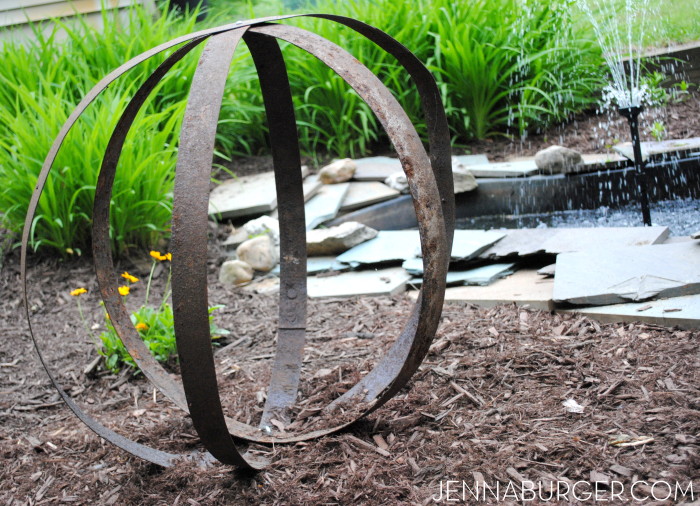 DIY: Outdoor Sculpture using metal straps from an old barrel.  Big impact with little work + no cost!