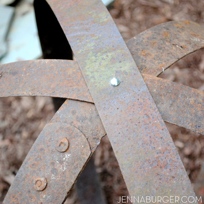 DIY: Outdoor Sculpture using metal straps from an old barrel.  Big impact with little work + no cost!