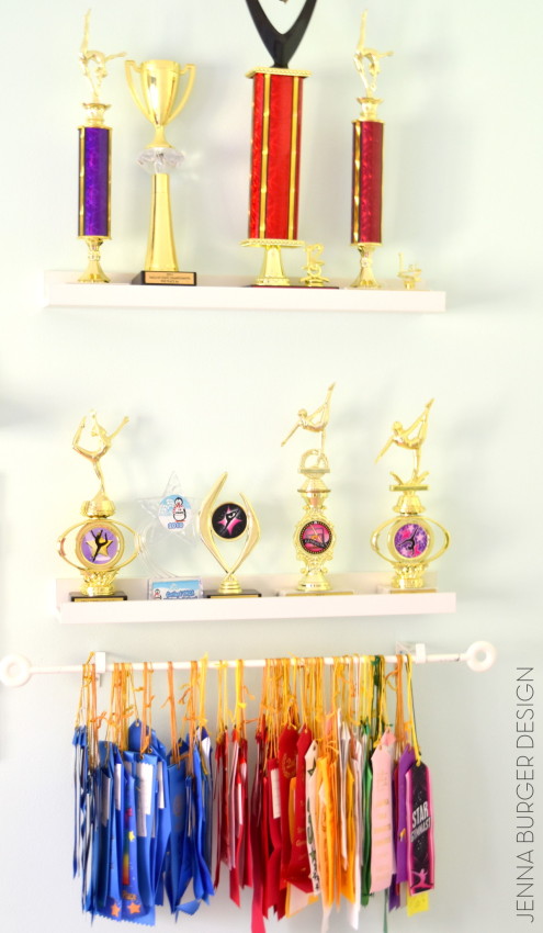 Hang ribbons using an inexpensive curtain rod + floating shelves for awards!