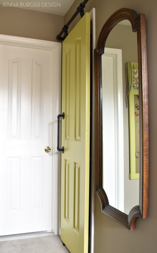 DIY: Rolling door hardware using plumbing pipe.  Get the look + function of a rolling door for about $60. Custom size to fit your space.  Tutorial by www.JennaBurger.com